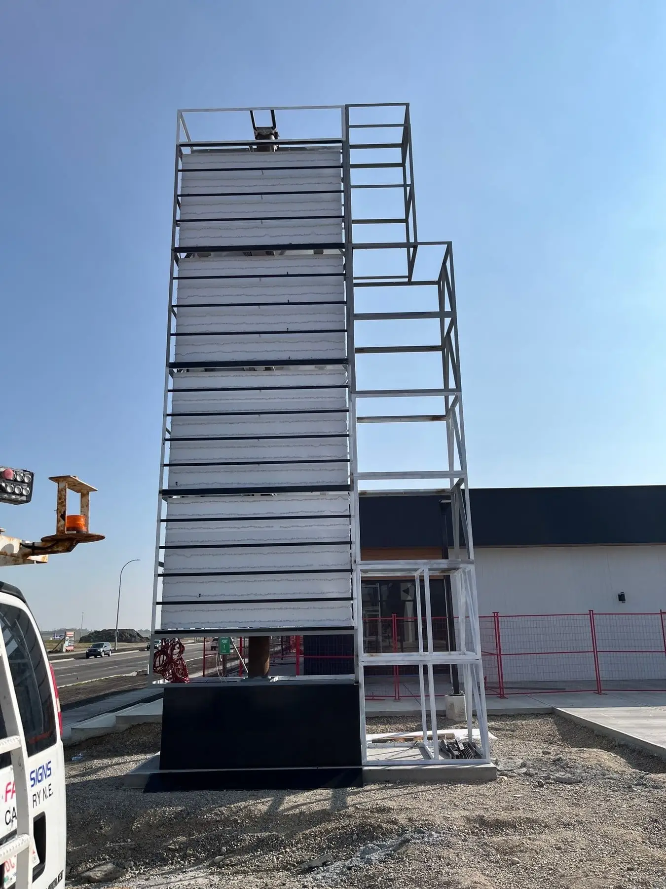 A pylon sign structure being lifted into position on a Calgary site by the installation crew