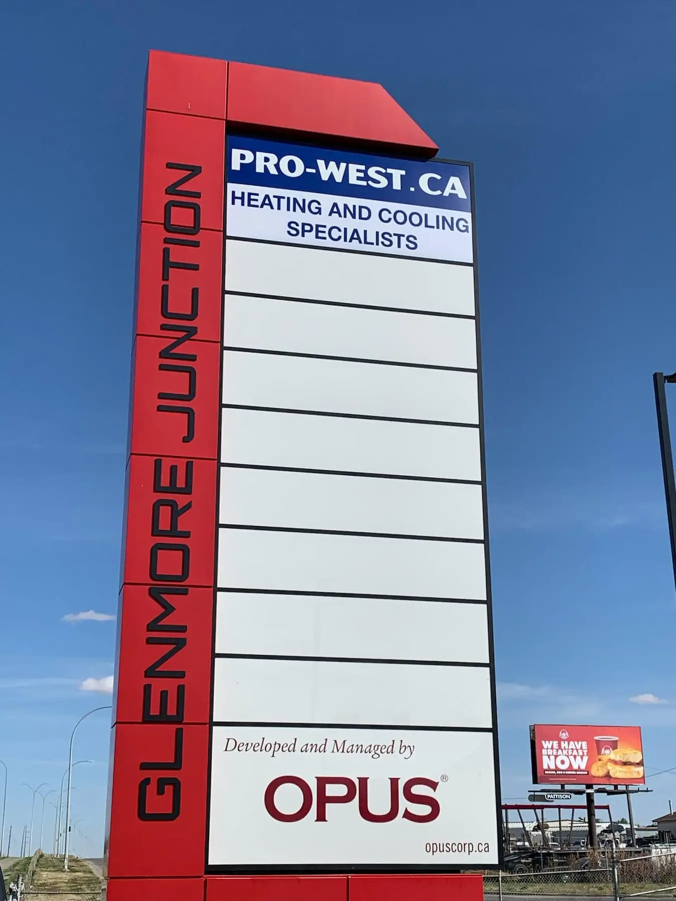 A tall freestanding pylon sign beside a Calgary retail development