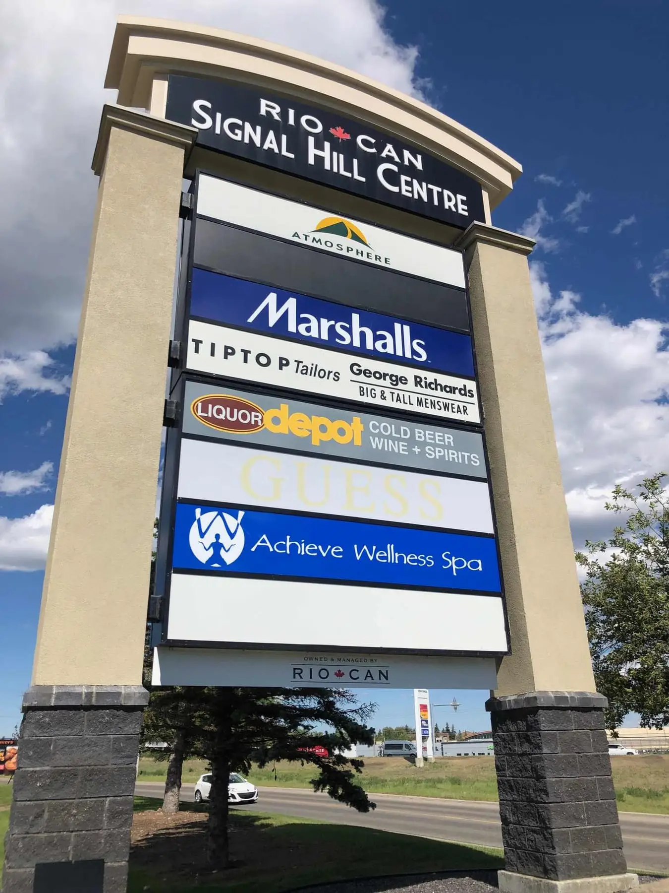 A tall multi-tenant pylon sign on a Calgary commercial corner