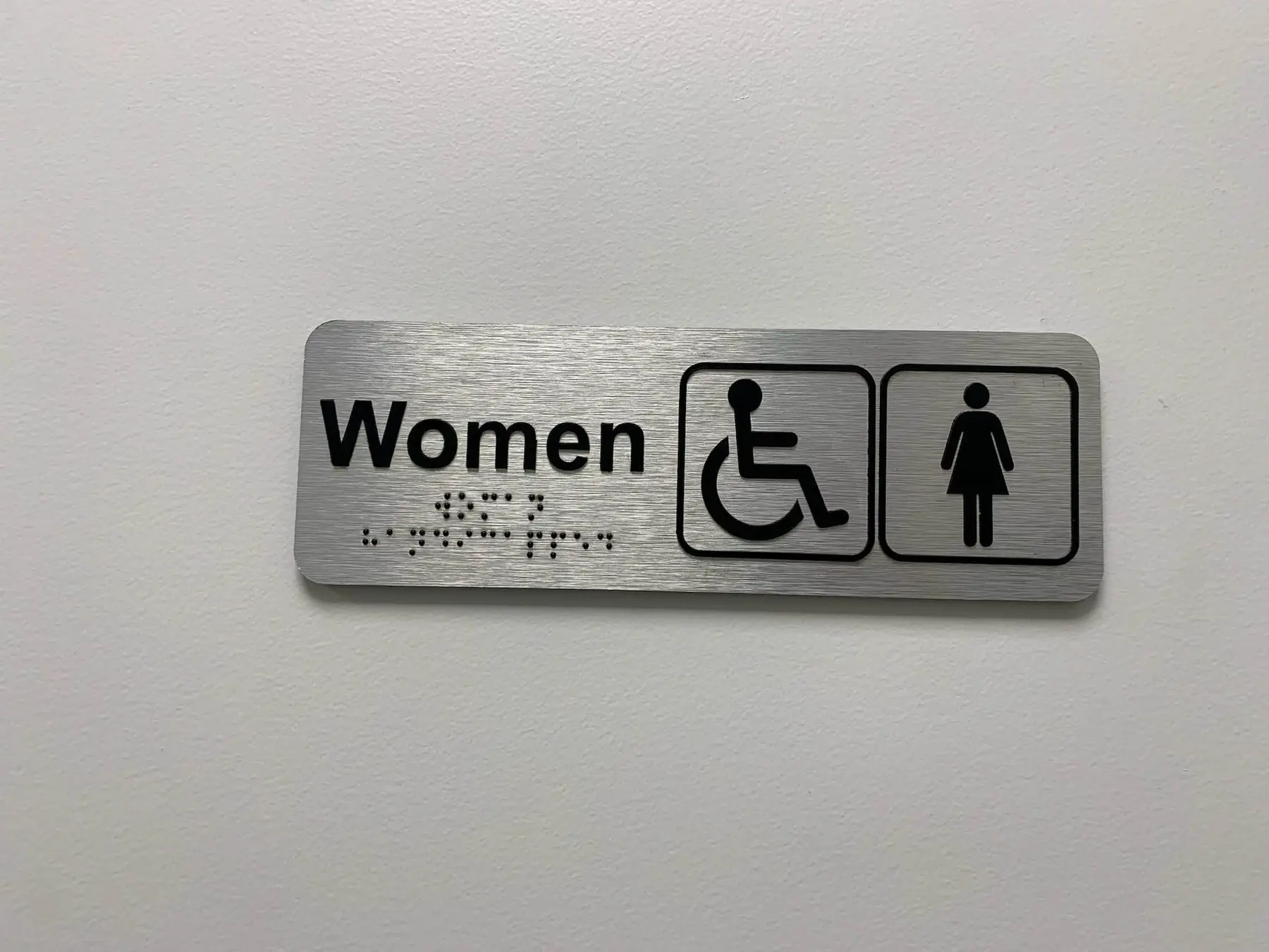 Tactile washroom identification signs with braille, made for a Calgary commercial building