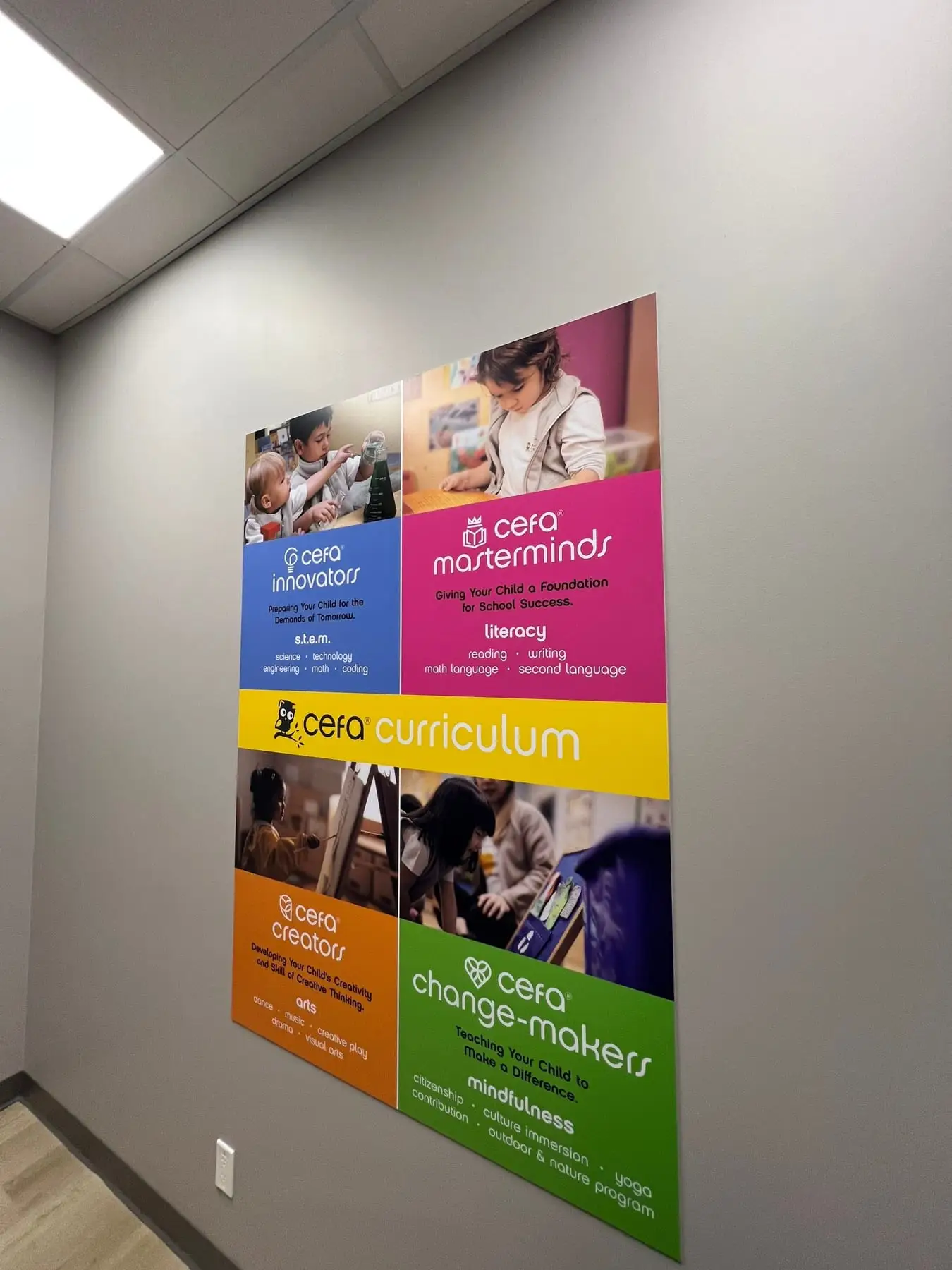 A corridor with printed wall graphics and directional panels inside a Calgary learning centre